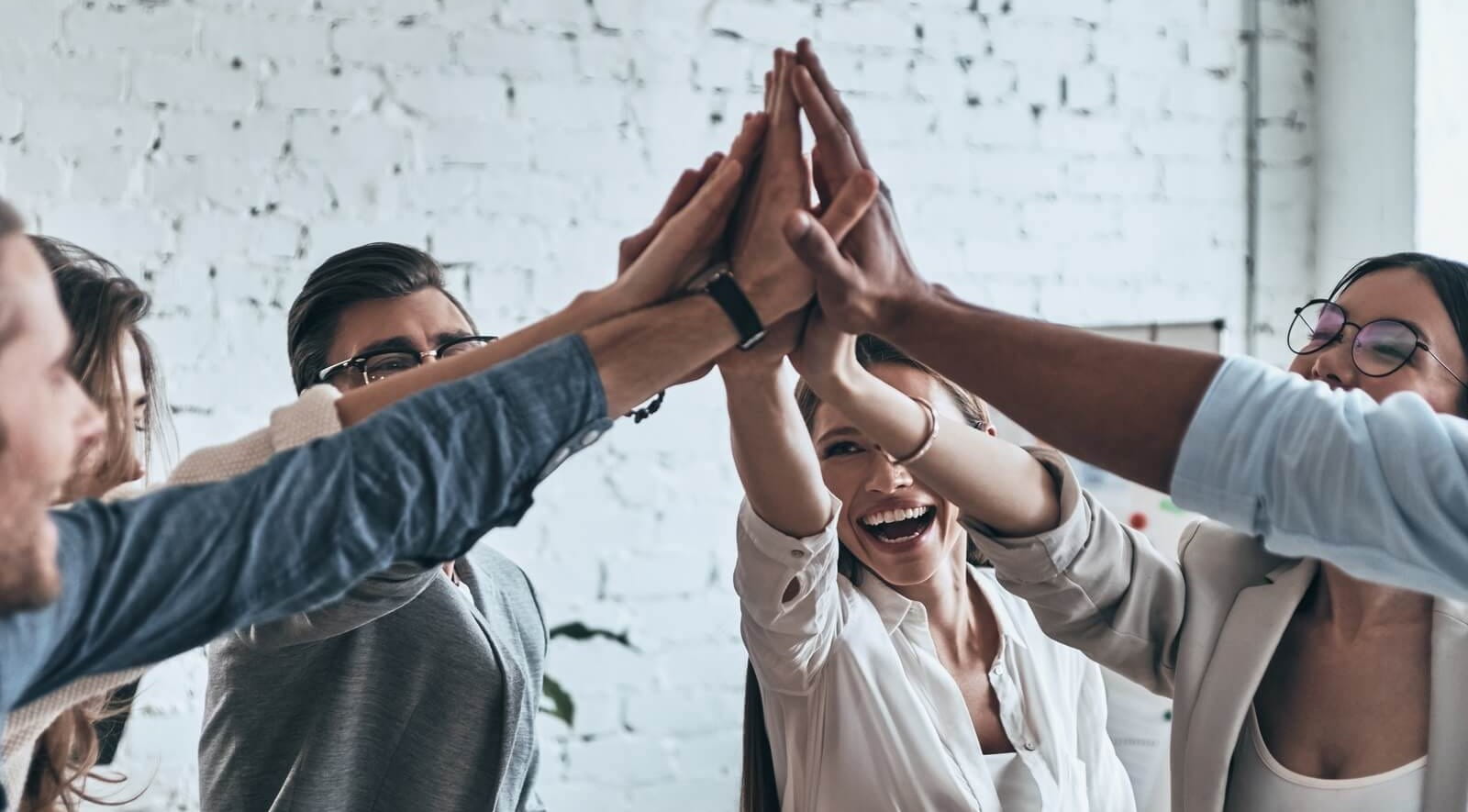 Young people in a group high five