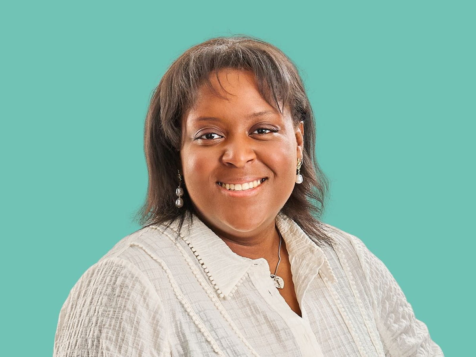 Image of a woman with a white buttoned linen shirt and a blue background